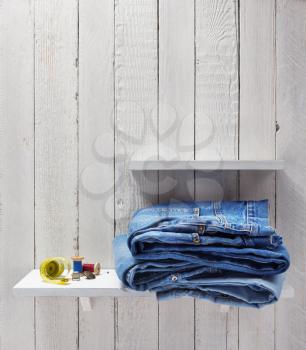 blue jeans on wooden shelf background
