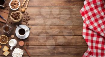 cup of coffee and beans on wooden background table, top view