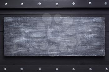 black wooden background as texture surface with screws