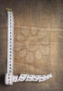 tape measure on wooden table background, top view