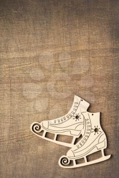 winter holidays concept with ice skates at wooden background texture, top view