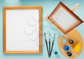picture frame and paints set on abstract background