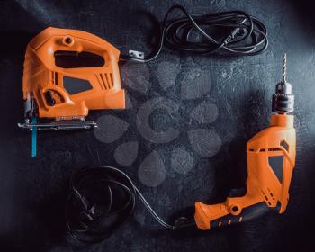electric tools with cord on black background