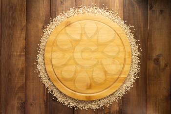 wheat grains on wooden background, top view