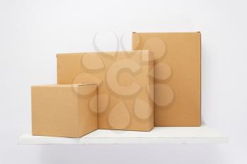 cardboard box on wooden shelf at white background