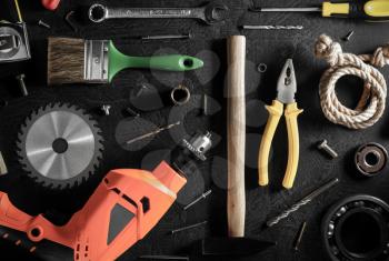 electric drill and tools  on black background