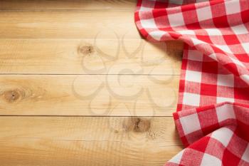 cloth napkin at rustic wooden plank board table background,