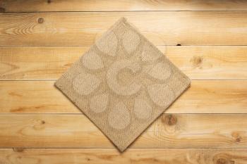 burlap hessian sacking cloth on wooden background table, top view