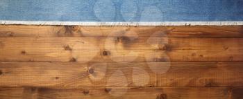 blue jeans texture on wooden background, top view
