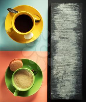 cup of coffee and tea at colorful background, top view