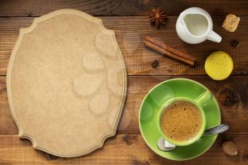 cup of coffee and ingredients at wooden background, top view