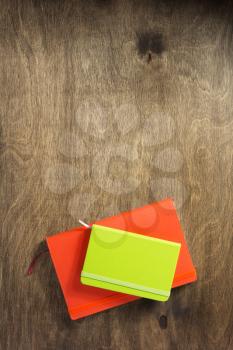 colorful notebook at wooden background texture