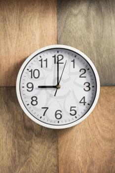 wall clock at wooden background surface