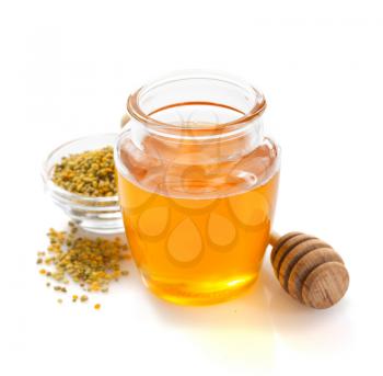 jar of honey and bee pollen isolated on white background