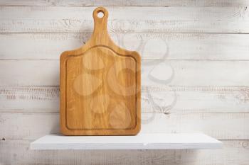 cutting board at shelf on white wooden plank background