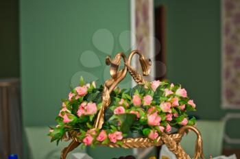 Basket with small roses indoors.