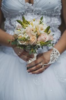 The girl holds a bunch of flowers.