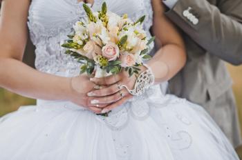 The girl holds a bunch of flowers.