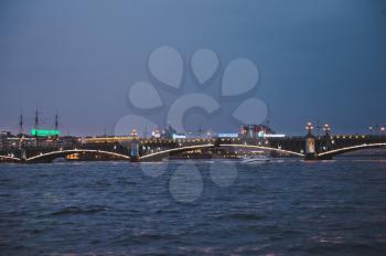Night shooting from the motor ship during the White nights, a view of Troitsky Bridge in the city of St. Petersburg.