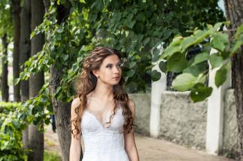 Photo of the girl in a wedding dress on the street.