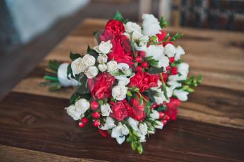 On a wooden table the bunch of flowers lies.