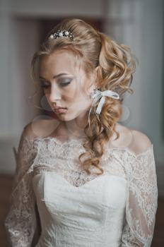 The girl in a thoughtful pose before wedding.
