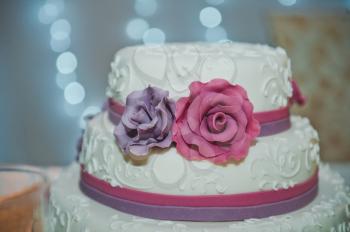 Big wedding cake with roses.