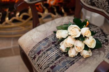 Bouquet from white roses on a beautiful chair.