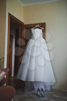 Lush white dress on a hanger.