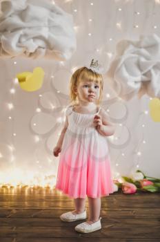 Little Princess against the background of lights and clouds.