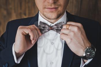 Man tying a bow tie.