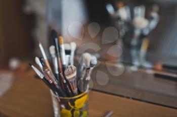 Brushes for applying makeup in a jar.