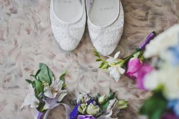 Shoes and flowers on the floor.
