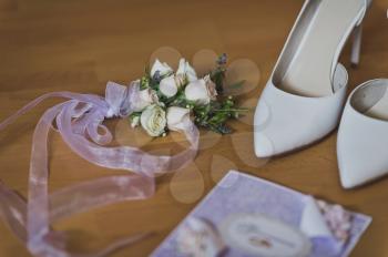 Beautiful elements of the wedding outfit of the bride on the table.