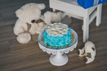 Baby cake decorated with blue cream.