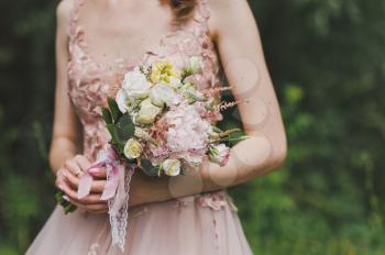 Bride holding a bouquet of flowers.