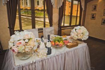 Banquet room with served meals and food tables.