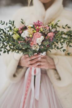 A bouquet of flowers in the girls hands.