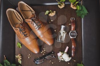 Men glasses watches and perfume with a boots.