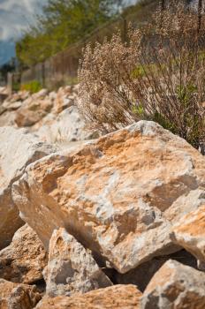 Limestone big rocks on the sandy shore.