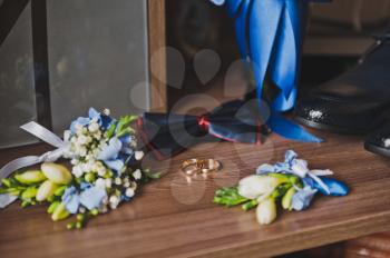 Boutonniere and mens wardrobe items on the table before the holiday.