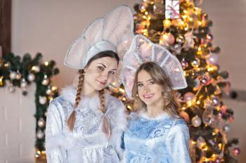 Studio portrait of two beautiful girls in fabulous costumes.