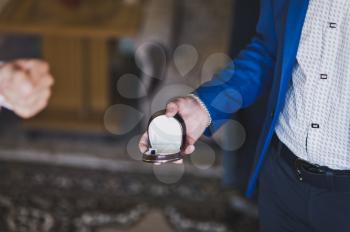 A man holding a box with wedding rings.