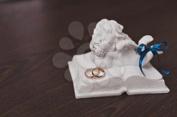 Angel figurine and wedding rings.
