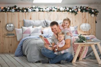 Mom, dad and two daughters are happily resting in the new year holidays at home.