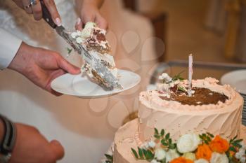 Newlyweds cut a birthday cake.