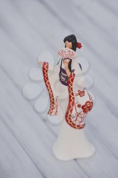 Decorative figure of a geisha in a Bathrobe and with a fan.