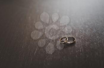 Wedding rings on the dark table.
