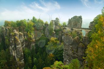 Bridge named Bastei in Saxon Switzerland Germany on a sunny day in autumn with colored trees and leafs