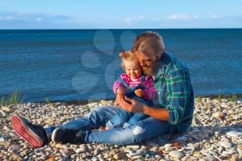 Dad and daughter at the sea walk by the sea. Family